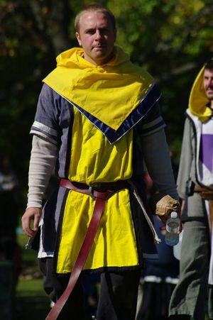 This marshal is wearing a yellow tabard and a yellow cowl that can be worn over other garb.
